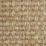 Close-up of a chunky natural beige jute carpet texture.