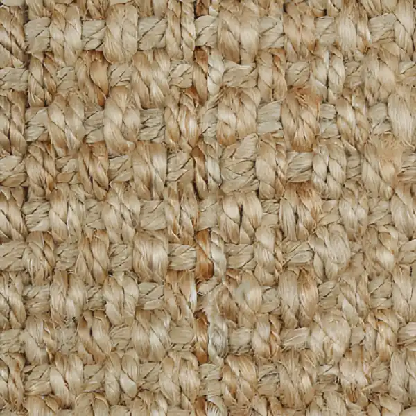 Close-up of a chunky natural beige jute carpet texture.