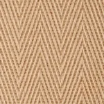 Close-up of a natural beige jute carpet with a chevron weave pattern.