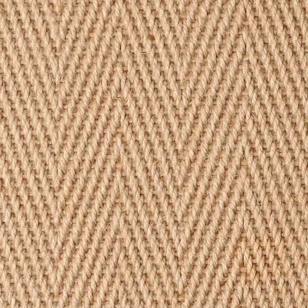 Close-up of a natural beige jute carpet with a chevron weave pattern.