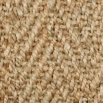 Close-up of a natural beige jute carpet with chunky woven fibers.