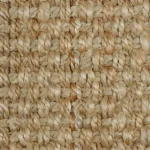 Close-up of chunky natural beige jute carpet fibers.