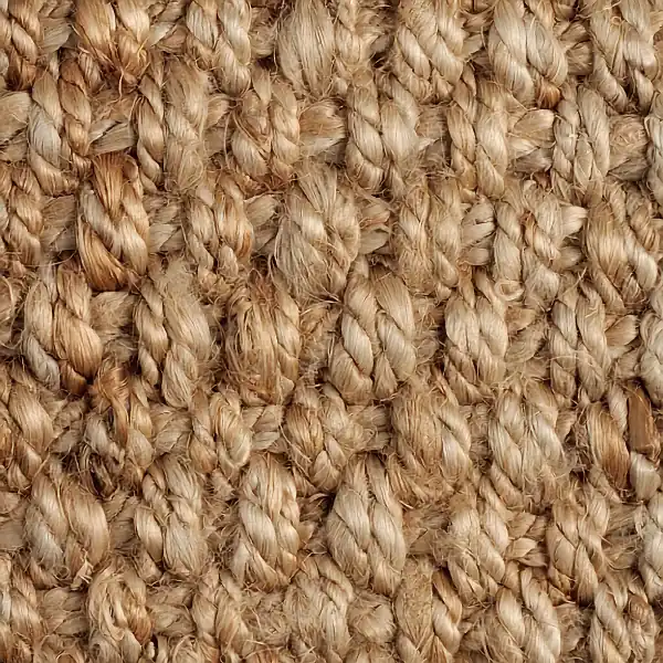 Close-up of shaggy natural beige jute carpet fibers.