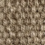 Close-up of thick, shaggy beige jute carpet fibers.