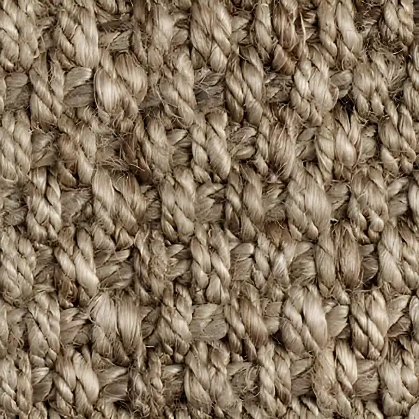 Close-up of thick, shaggy beige jute carpet fibers.