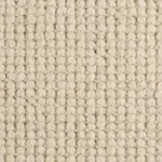 Close-up texture of a chunky off-white wool loop pile carpet.
