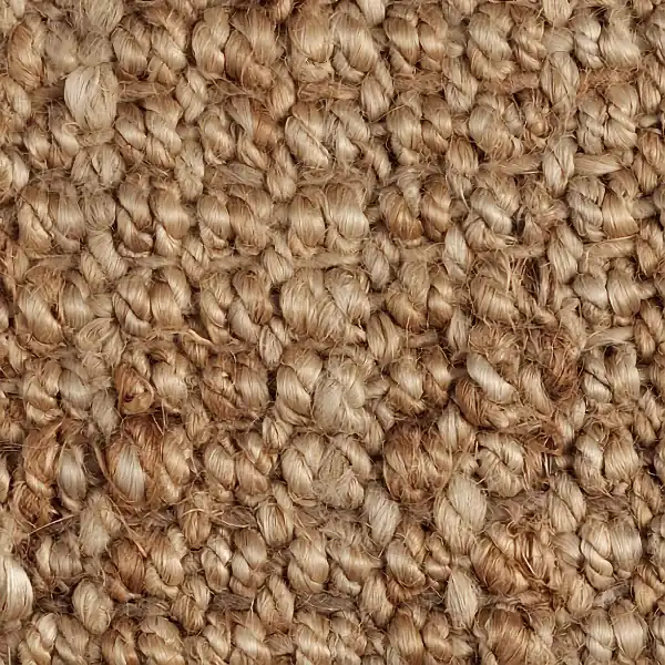 Close-up texture of a natural beige jute carpet.