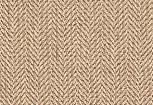 Close-up texture of a neutral beige wool herringbone carpet.