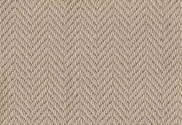 Close-up texture of a warm taupe wool herringbone carpet.