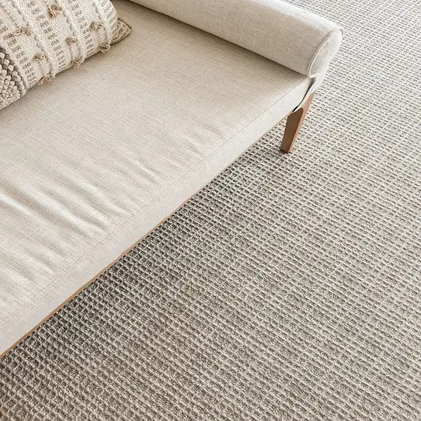 Textured beige wool wall to wall carpet near sofa