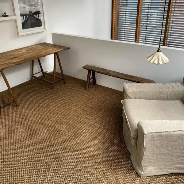 Textured brown sisal wall-to-wall carpet installed in a bright home office