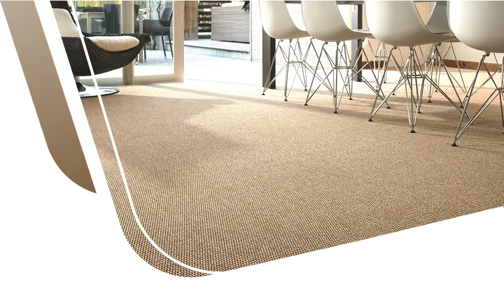 Textured natural sisal carpet flooring installed in a bright, modern dining room