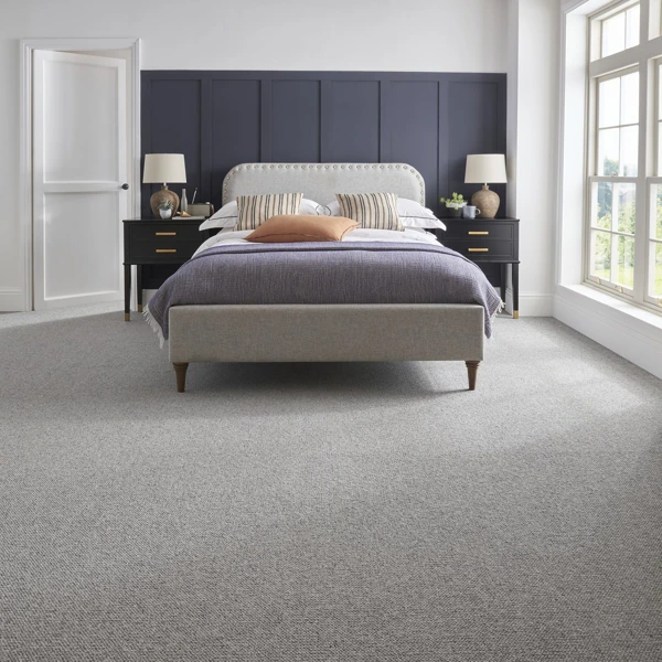 Light grey textured wool blend wall to wall carpet