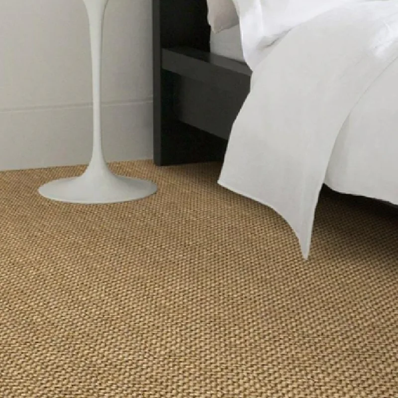bedroom corner featuring a beige sisal carpet,