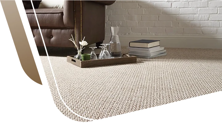 natural jute loop pile carpet flooring displayed next to a brown leather armchair